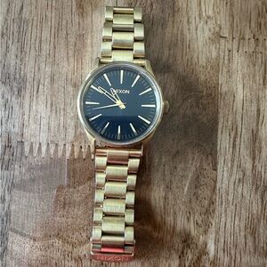 Nixon gold watch with black face